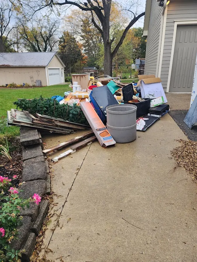 Dumpster being loaded with debris for Estate Cleanout Dumpster Rental in Highland Falls